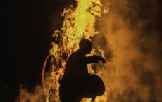 silhouette in front of a fire