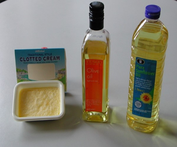 Different types of fat.  Solid cream (animal-derived), containing mostly saturated fats; olive oil, liquid at room temperature (but solid in the fridge), and sunflower oil, with mostly ‘kinky’ polyunsaturated fatty acids, and very liquid.  Note that in each case the fat is in the form of triacylglycerol (TG).