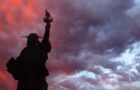 Silhouette of the statue of liberty at sunset